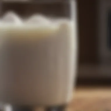 A close-up view of fresh goat milk in a glass, highlighting its creamy texture and color.